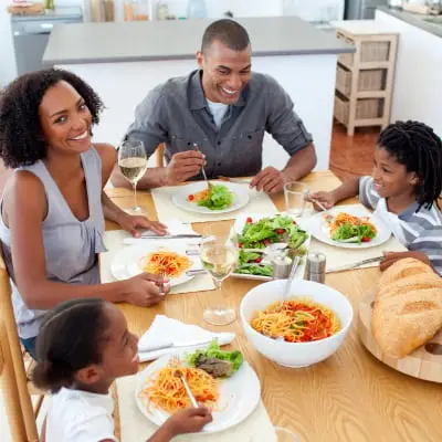 a happy family eating together